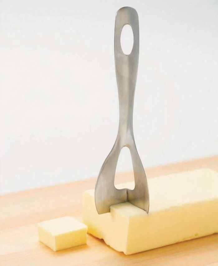 Butter cutter tool slicing a stick of butter into perfect cubes, one of the interesting tools solving small kitchen problems.