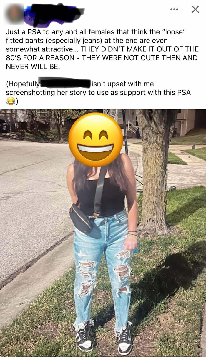 Woman wearing ripped jeans and a black tank top stands on a sidewalk, illustrating men’s entitlement in fashion opinions.