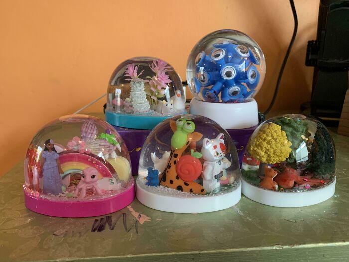 A collection of varied snow globes, showcasing consumerism and price difference.
