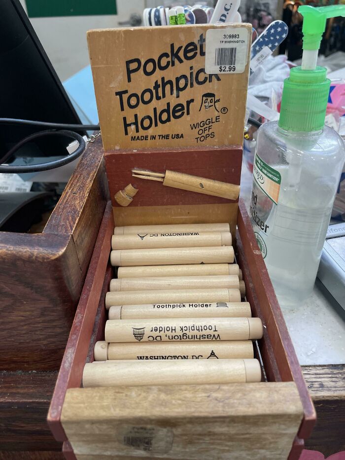 Pocket toothpick holders displayed in a wooden box, offering a handy tool to solve a small everyday annoyance.