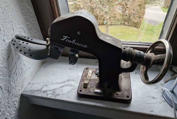 Vintage metal shoe stretching tool on a windowsill, an interesting tool that might solve an annoying little problem.