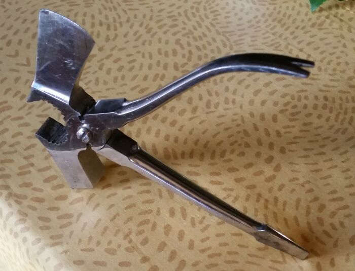 Multi-functional metal tool for small repairs and tasks, showcasing unique design among interesting tools that solve annoying problems.