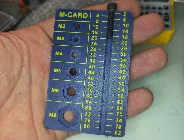 Handheld measuring tool with labeled holes and scale, one of many interesting tools solving annoying little problems.