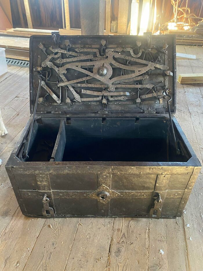 Intricate metal locking mechanism inside an old chest showcasing remarkable metalworker craftsmanship and design.