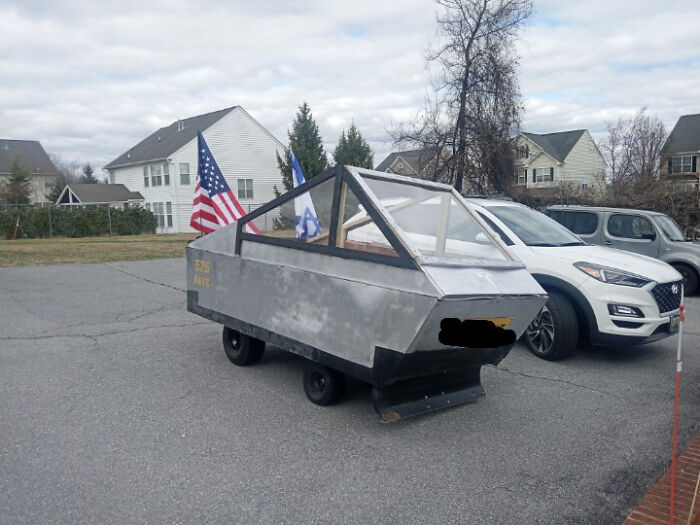Homemade DIY vehicle resembling a crude futuristic car, parked in a neighborhood, showcasing a cringe moment.