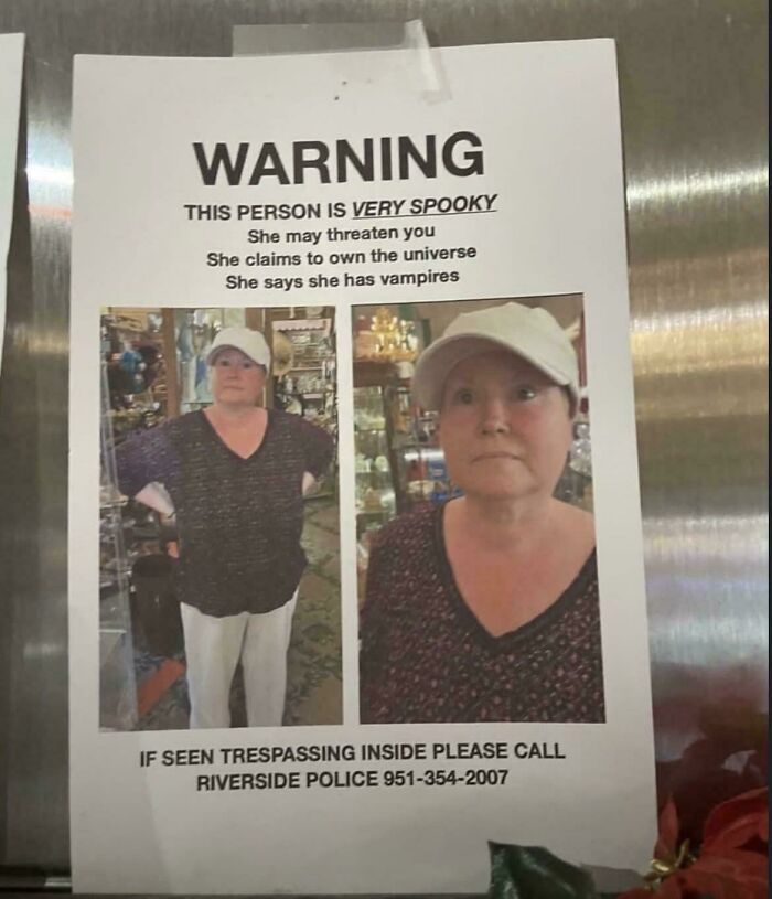 Warning sign showing a woman described as very spooky with humorous claims to own the universe and having vampires in cringe moment.