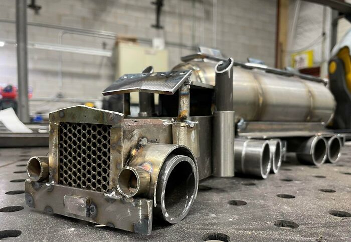 Metalworkers’ intricate metal truck model showcasing skill and creativity in defying physics and logic with remarkable craftsmanship.