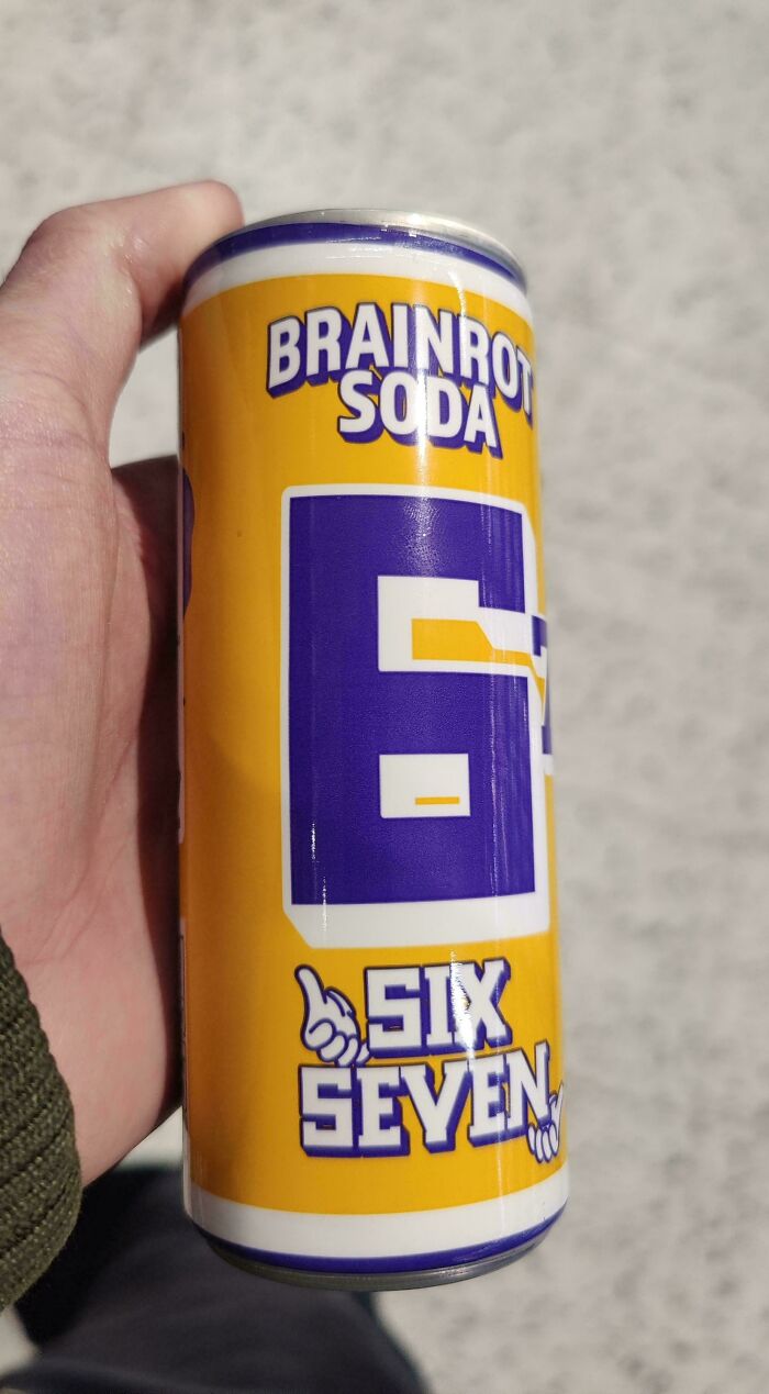 Hand holding a yellow can labeled Brainrot Soda with a large blue number six and the words six seven in bold letters.