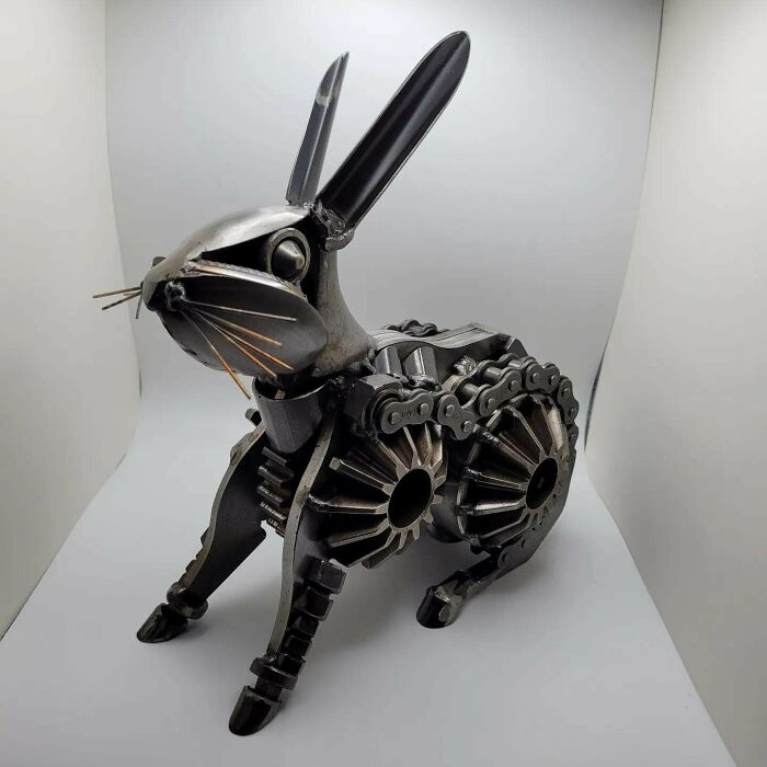 Metal sculpture of a rabbit made from gears and metal parts, showcasing metalworkers defying physics and logic.
