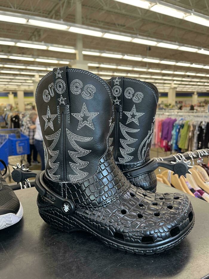 Black Crocs boots with star and croc skin patterns displayed on a shelf, showcasing cringe fashion moments.