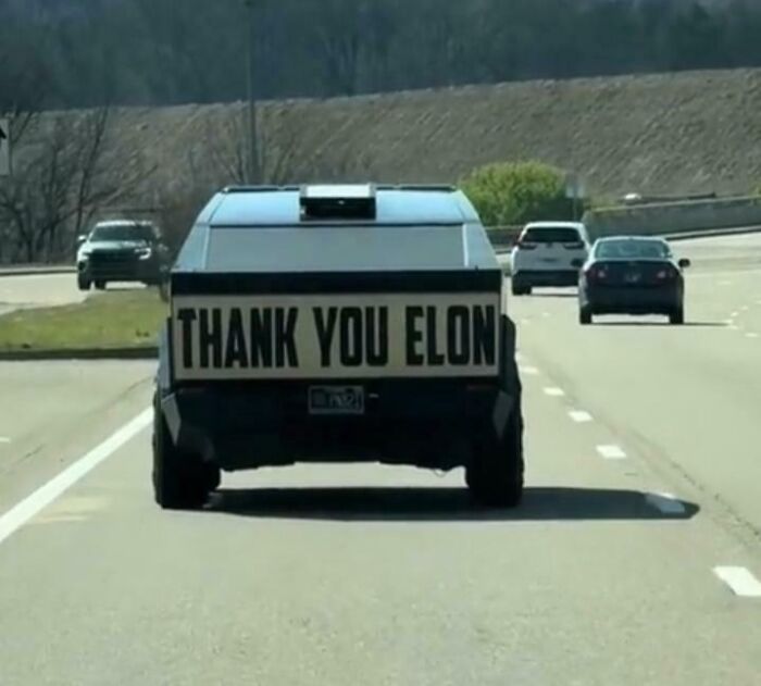 Truck on highway with large sign reading thank you Elon, an example of cringe moments captured in new pics.