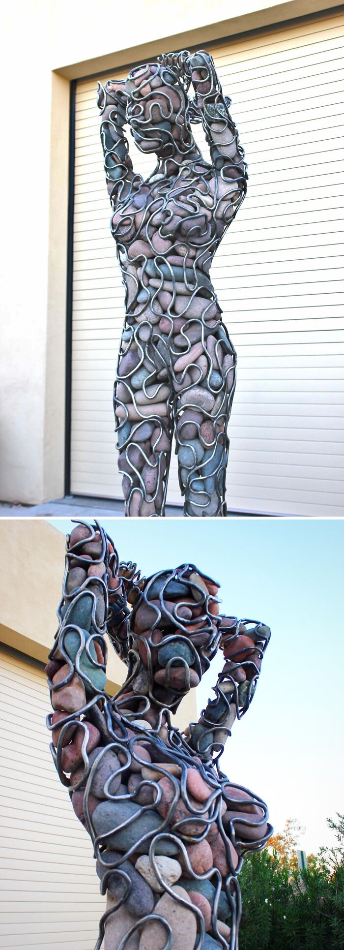 Metalworkers sculpture of a human figure made from stones held together by intricate metalwork outdoors.