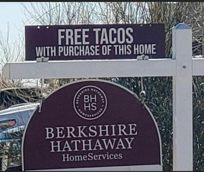 Sign offering free tacos with home purchase, an example of strange signs that catch attention and deserve a double take.
