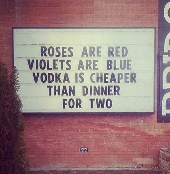 Funny strange sign on a brick wall with a poem about vodka being cheaper than dinner for two, showing unusual sign humor.