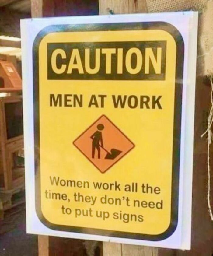 Funny strange caution sign with men at work and a humorous message about women working all the time.