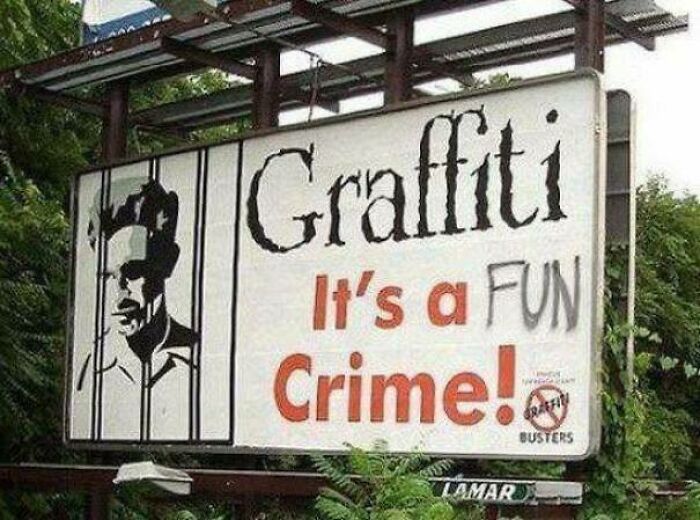 Sign reading graffiti is a crime altered with the word fun graffiti showing a strange and unusual street message.