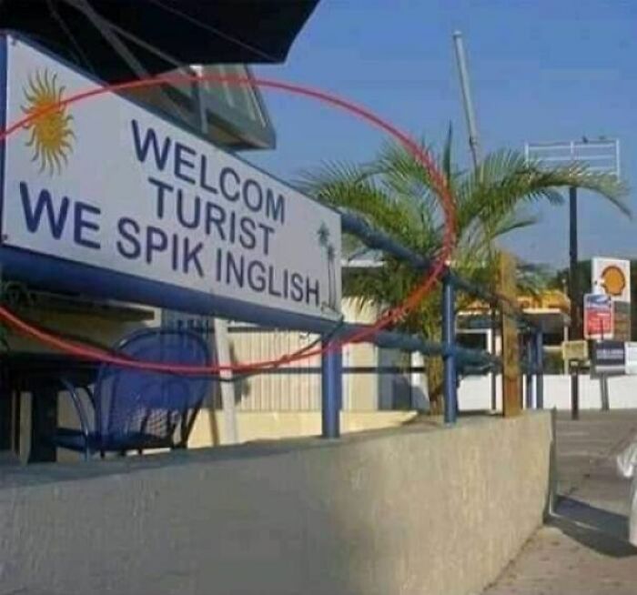 Sign with misspelled words welcoming tourists, illustrating strange signs that deserve a double take.