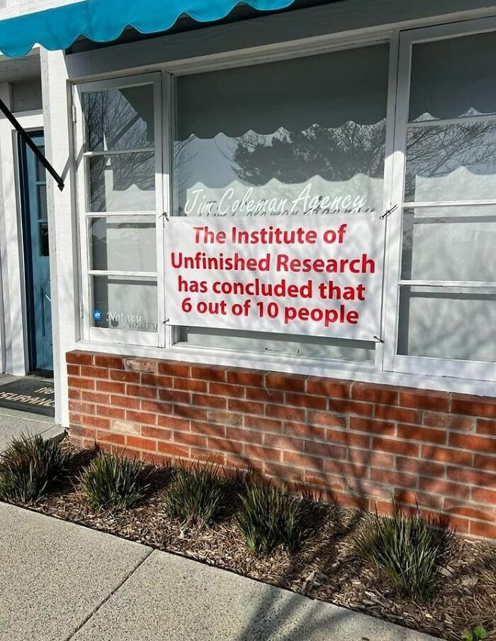 Sign outside a building humorously stating unfinished research with a partial statistic, highlighting strange signs to double take.