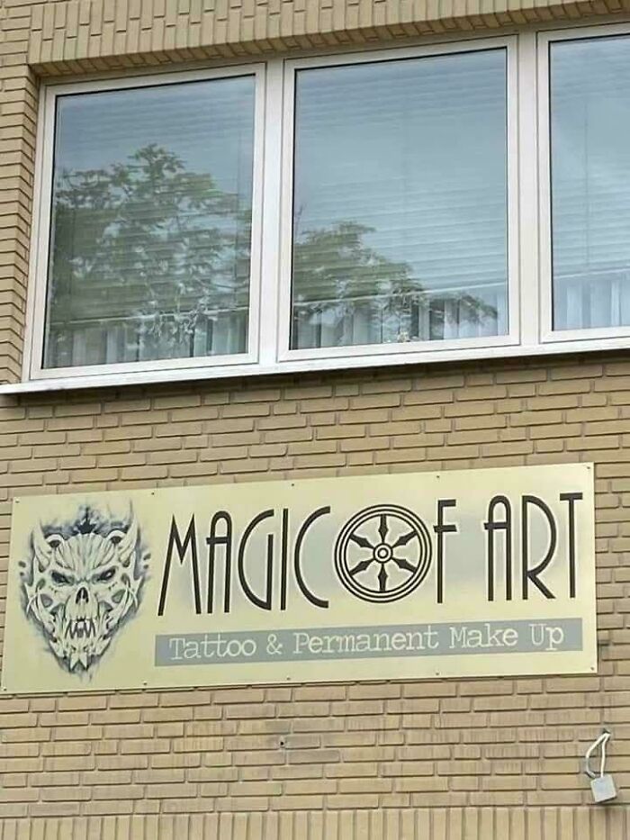 Sign outside a building with a creepy skull logo and stylized text, an example of terrible product design flaws.