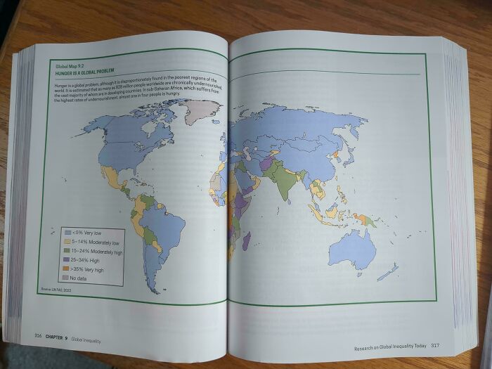 Open book showing a global map with color-coded regions, illustrating data on hunger as a terrible product design example.