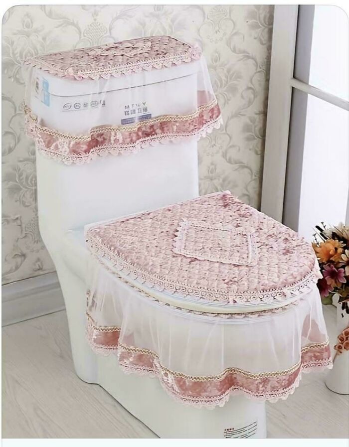 Toilet covered with elaborate lace and fabric, showcasing one of the terrible product designs that should have never seen the light of day.