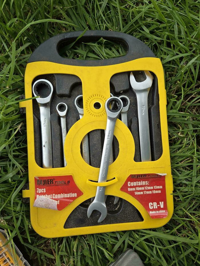 Poorly designed toolset with a wrench awkwardly strapped to yellow plastic case, an example of terrible product designs.