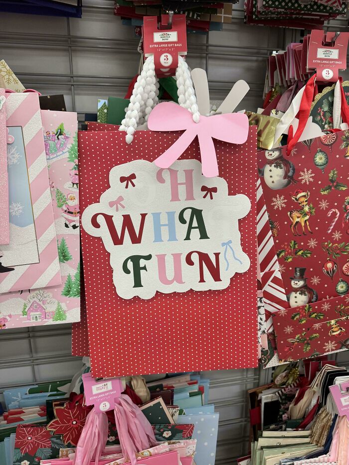 Red polka dot gift bag with a pink bow and misspelled holiday greeting showing terrible product design.