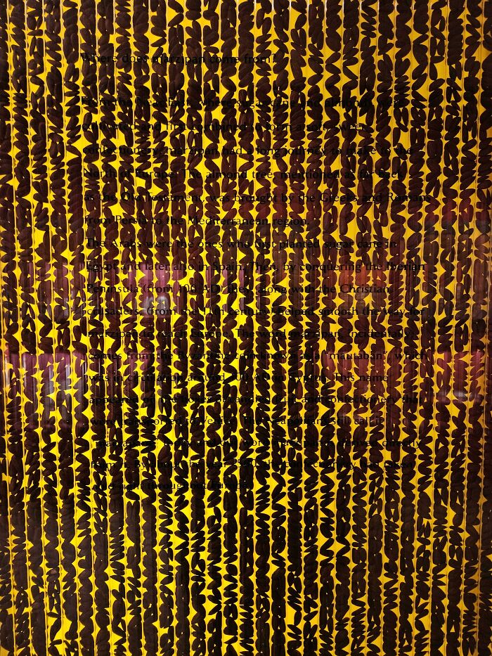 Close-up of a product with a dense pattern of irregular black shapes on a yellow background, showing terrible product design.