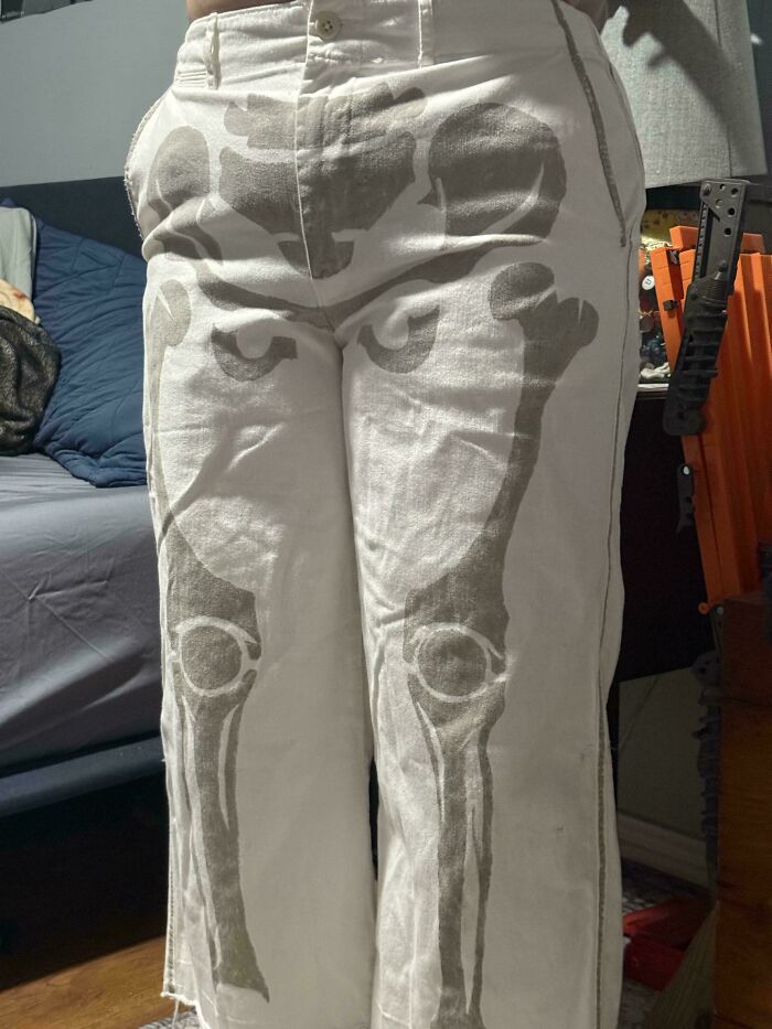 White pants with grey skeleton bone prints, a unique fashion find from dumpster diving.
