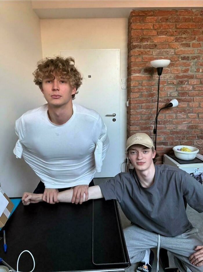 A picture of two young men showing off their long arms, an example of online lies.