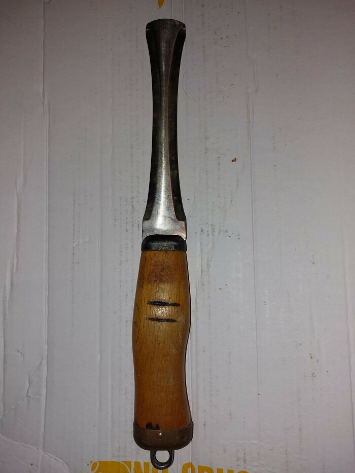 Old wooden-handled tool with a metal blade that looks unusual, featured in strange pics showing utter confusion.