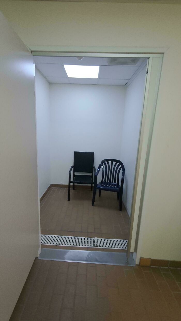 Small empty room with two different chairs inside, a strange pic that shows confusion in a minimal setting.