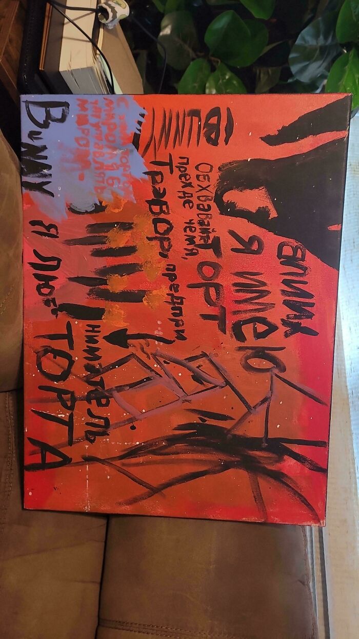 Abstract painting with bold black and orange colors and confusing text, one of the strange pics that leave viewers utterly confused.