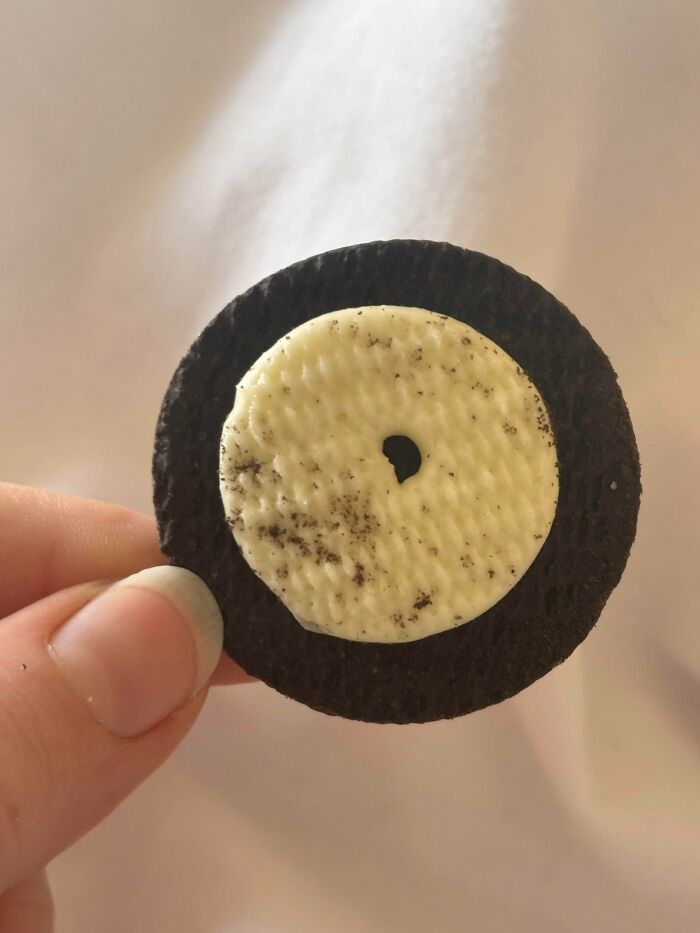 Close-up of cookie with significantly reduced cream filling illustrating shrinkflation in everyday products.