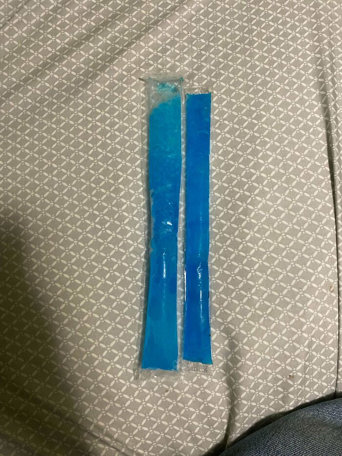 Two blue ice pops in clear plastic packaging side by side showing obvious shrinkflation comparison.