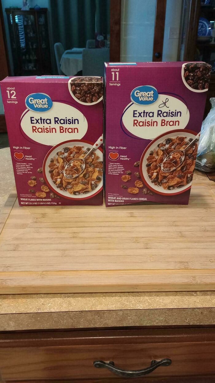 Two boxes of Great Value raisin bran cereal on a kitchen counter illustrating obvious shrinkflation difference in servings.