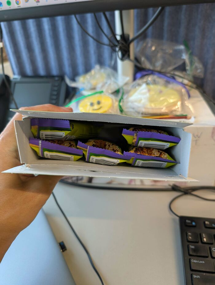 Open snack box showing fewer individually wrapped bars inside, illustrating obvious shrinkflation and consumer product downsizing.