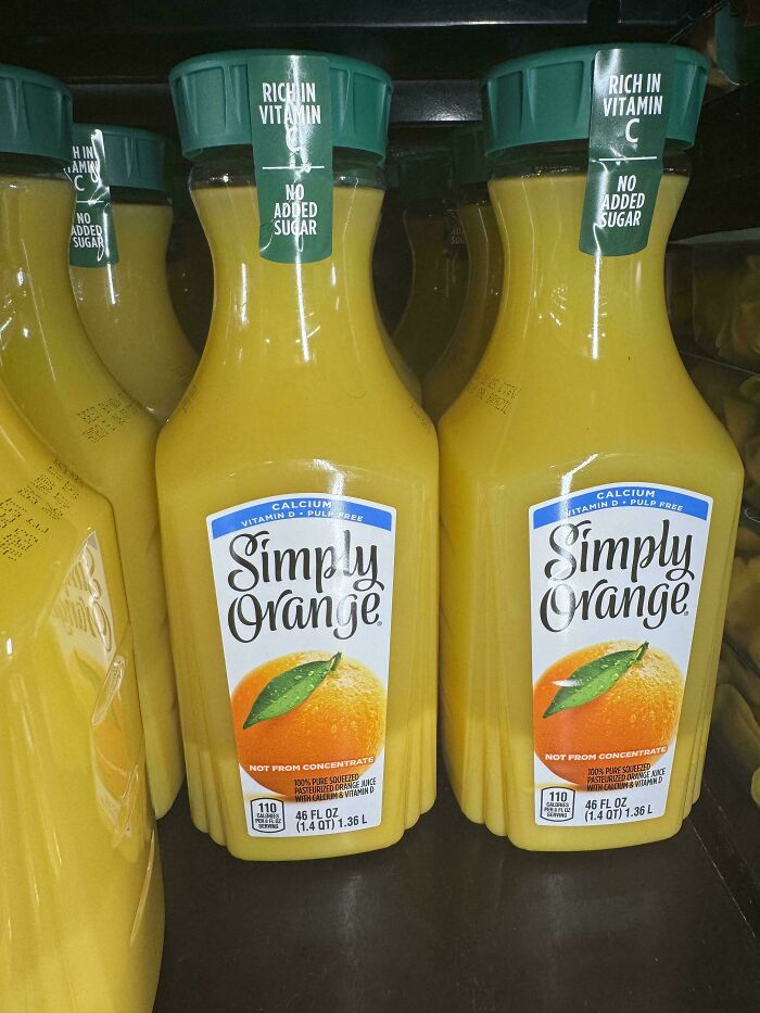 Bottles of Simply Orange juice showing shrinkflation with reduced liquid volume labeled as rich in vitamin C and no added sugar.