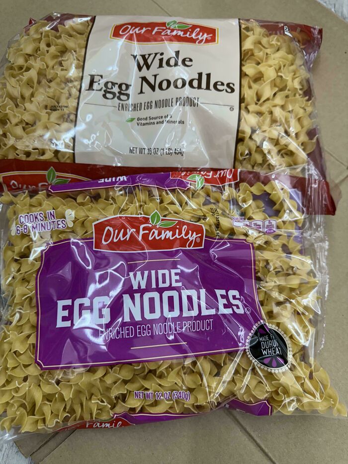 Two packages of Our Family wide egg noodles showing obvious shrinkflation in product size difference.