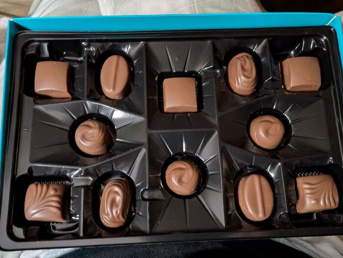 Box of assorted chocolates with missing pieces highlighting shrinkflation issues in America’s consumer products.