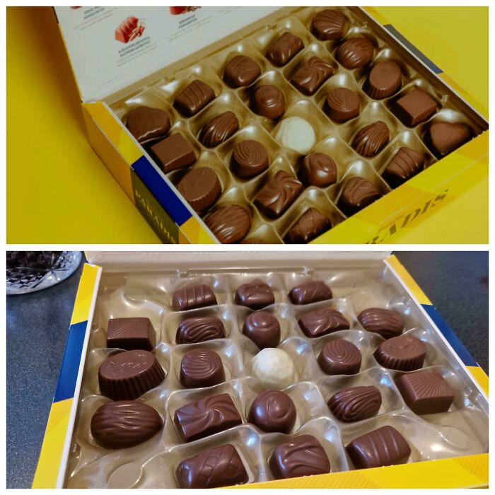 Open box of assorted chocolates showing obvious shrinkflation with fewer pieces in the same packaging size.