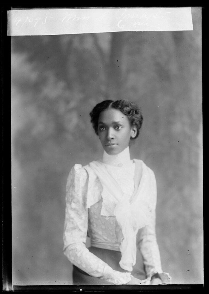 Black and white vintage portrait of a poised woman from decades ago capturing history in a powerful photo.