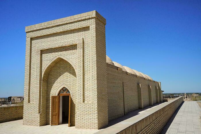 Ancient brick artefact structure under clear blue sky, showcasing historical architecture that survived to give perspective on humanity.