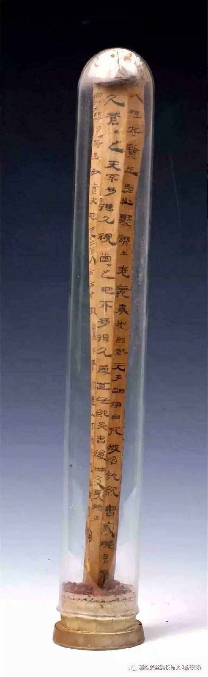 Ancient artifact with Chinese script inside a glass container, showcasing fascinating artefacts that survived to this day.