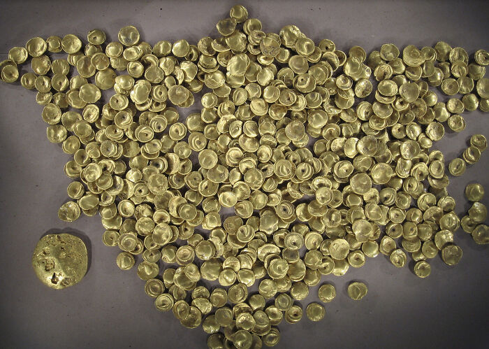 Ancient gold coins and artefacts displayed to show fascinating artefacts that survived to give perspective on humanity.