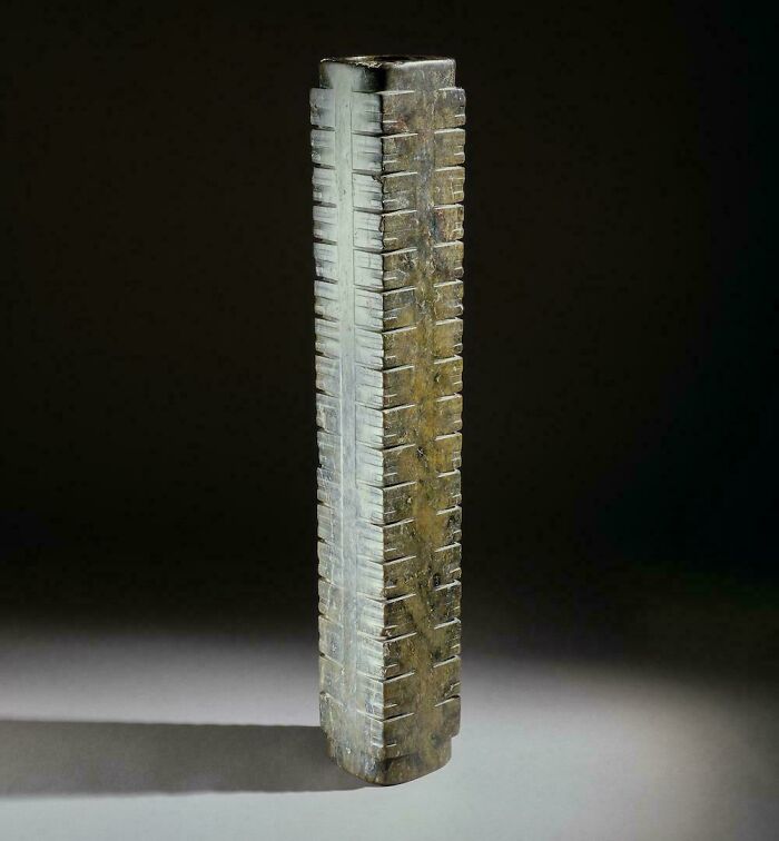 Ancient carved artefact made of stone with incision marks, an intriguing artefact that survived to this day showing historical craftsmanship.