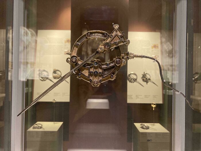 Intricately designed ancient artefact displayed in a glass case, showcasing craftsmanship and history preserved through time.