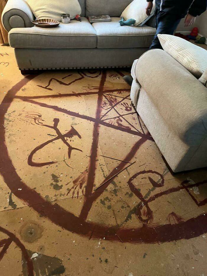 Living room floor featuring a large strange earth pentagram symbol creating a borderline unbelievable scene.