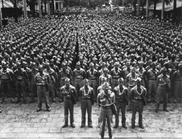 Large group of historical soldiers standing in formation, representing a vastly different world from today in this vintage photo.