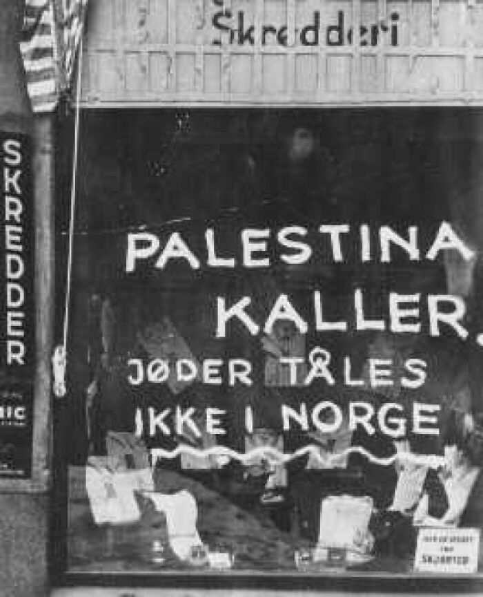 Historical photo of a storefront with anti-Semitic graffiti, representing a vastly different world from today.